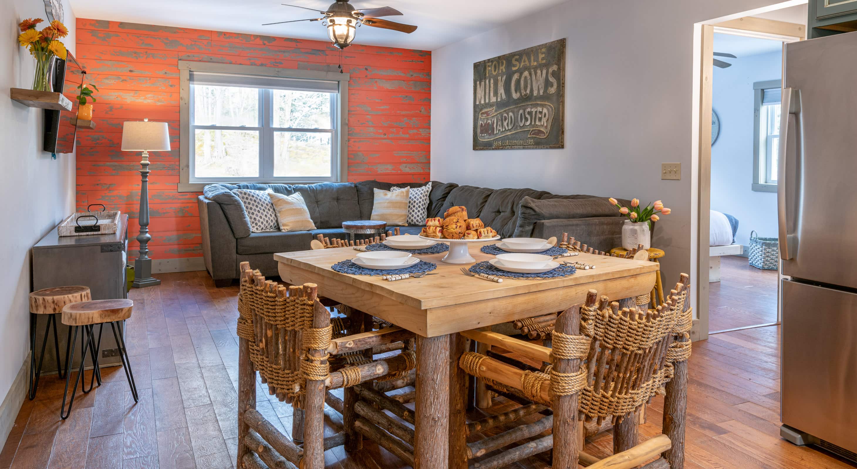 Dining table for four and living room area in comfortable accommodations in Vermont
