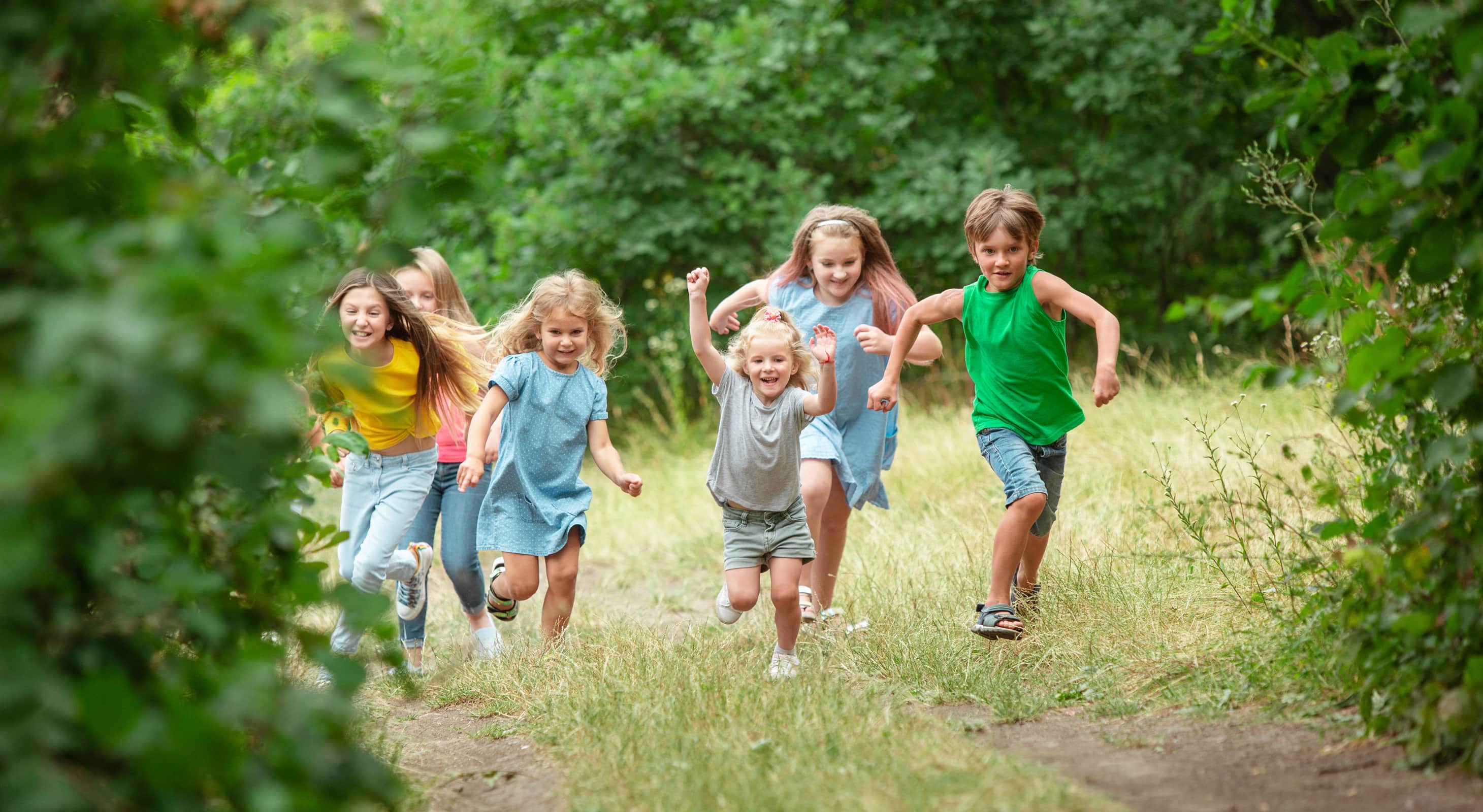 Group of happy kids running outdoors