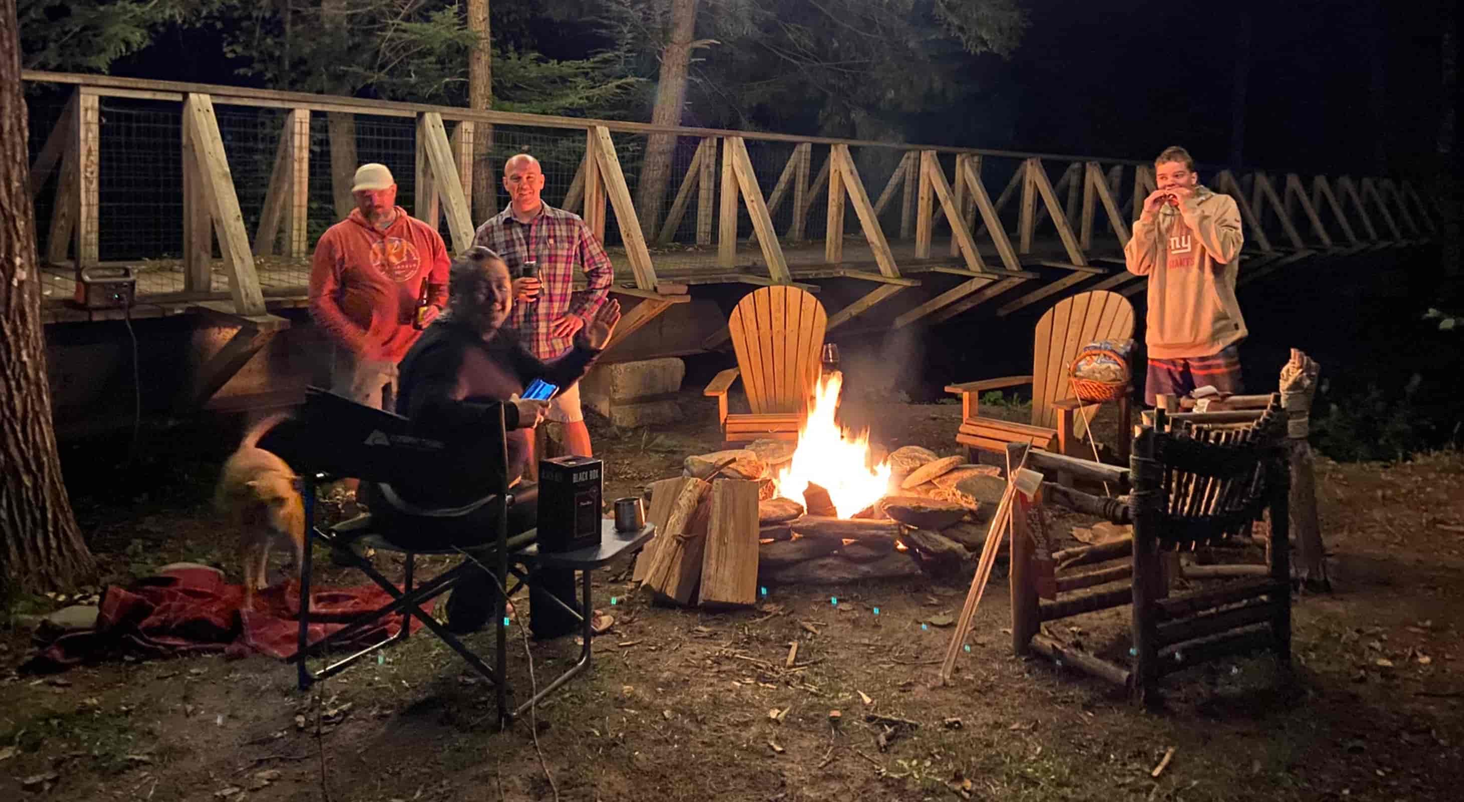 Group enjoying outdoor firepit at night at our Waitsfield, VT Lodge